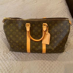 Gentry used Louis Vuitton duffle bag.